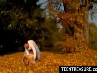 Chick couple petting in park on nice autumn day